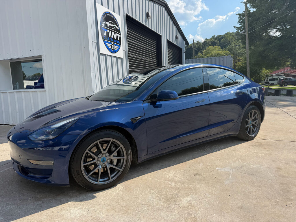 Blue sedan with window tint outside the Tint Chattanooga studio